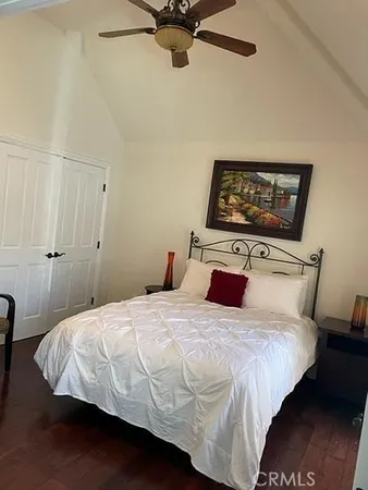 a bedroom with a bed and a painting on the wall