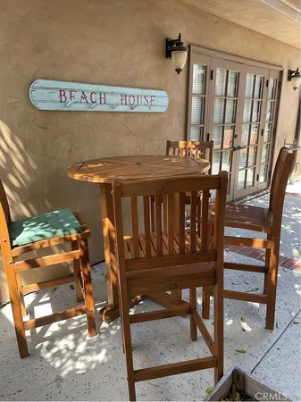 a view of a chairs and table in the balcony