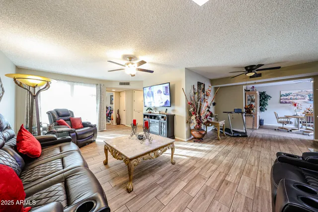 a living room with furniture and a wooden floor