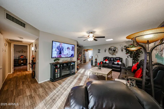 a view of a livingroom with furniture and a flat screen tv