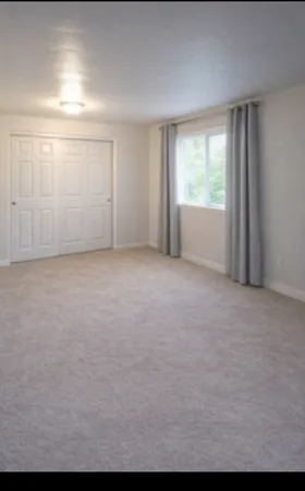 a bathroom with a granite countertop bathtub shower sink vanity and toilet