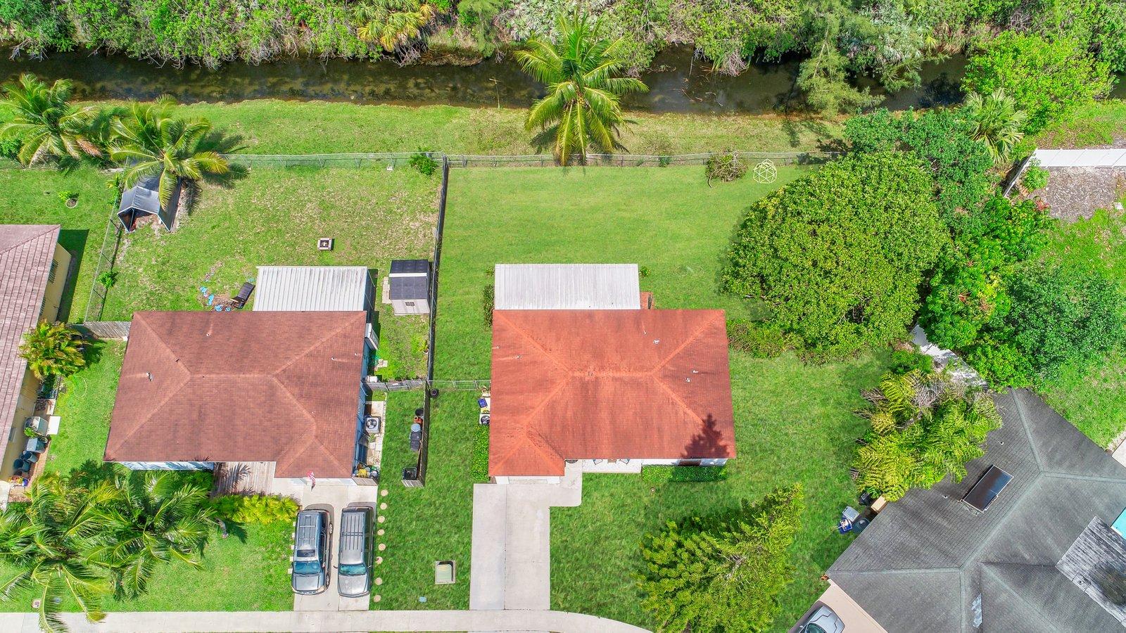 22047 Caldera Avenue Boca Raton, FL 33428 - Photo 61 of 61 an aerial view of a house with a yard and lake view