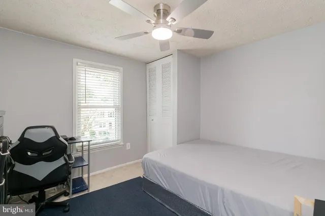a bathroom with a granite countertop toilet sink and mirror