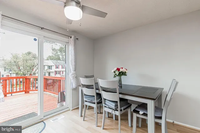 a dining room with furniture a chandelier and wooden floor