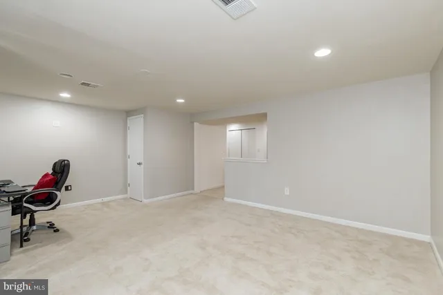 a view of kitchen with furniture and a refrigerator
