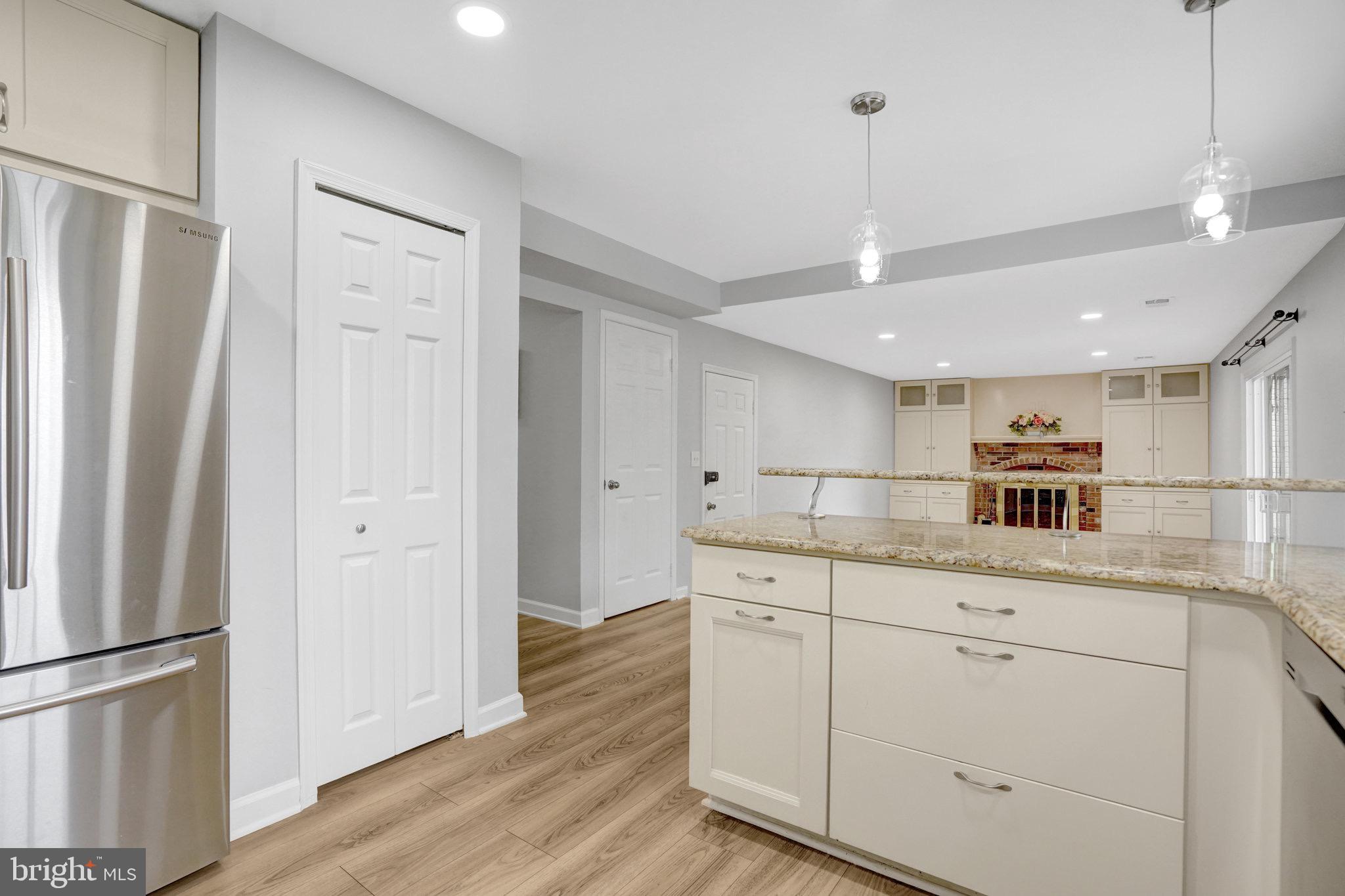 8298 Lindside Way Springfield, VA 22153 - Photo 14 of 38 a kitchen with white cabinets and stainless steel appliances