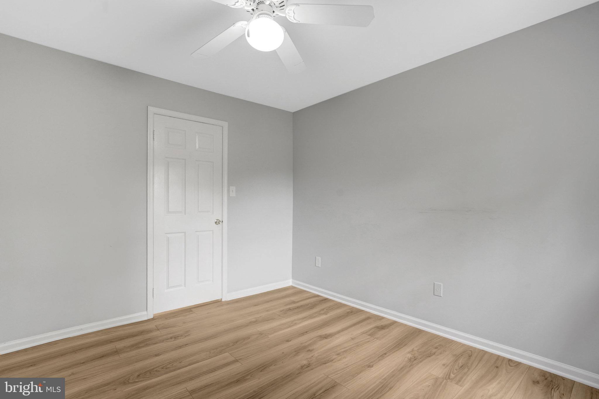 8298 Lindside Way Springfield, VA 22153 - Photo 19 of 38 a view of an empty room with wooden floor