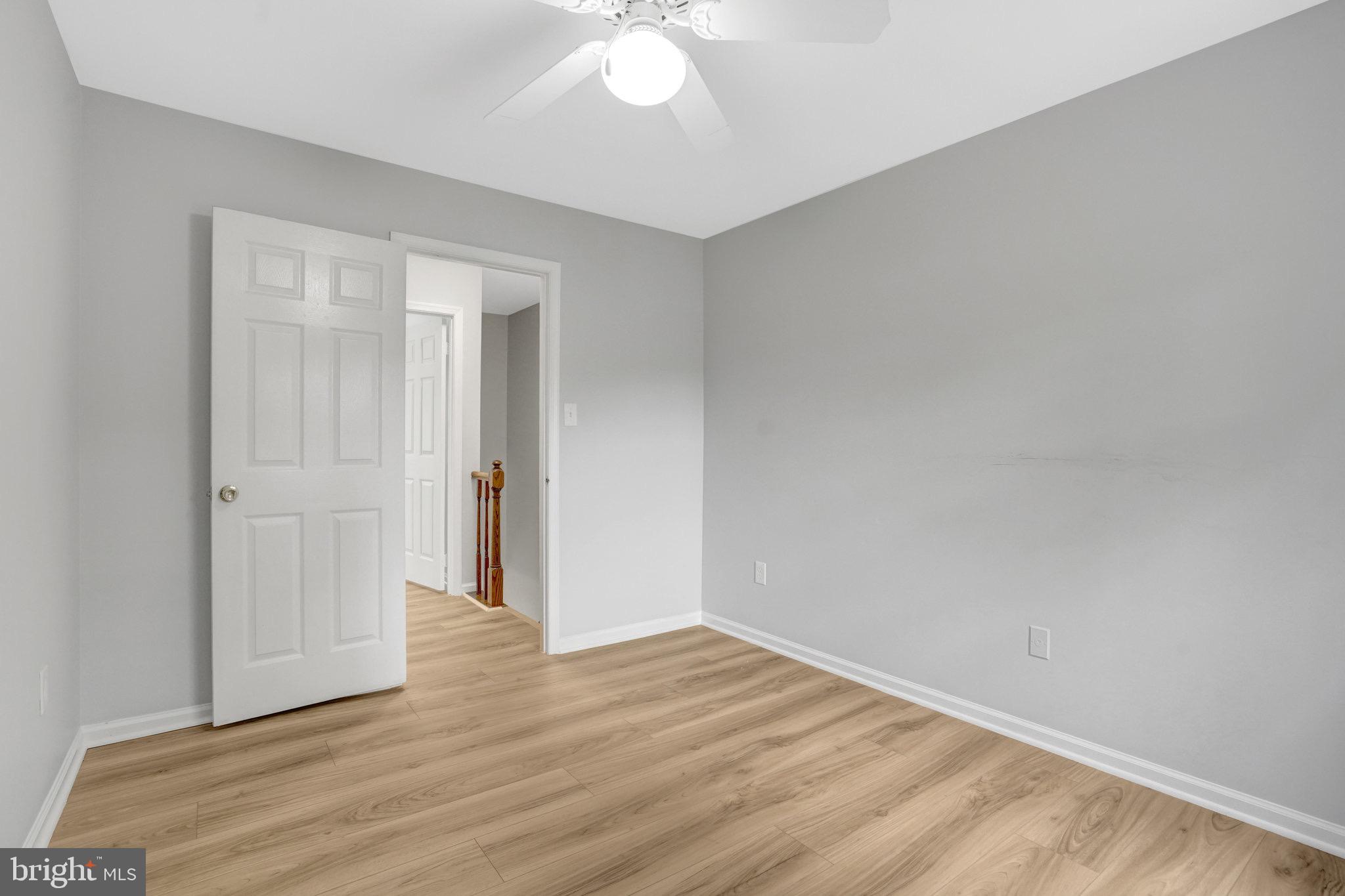 8298 Lindside Way Springfield, VA 22153 - Photo 20 of 38 a view of an empty room with wooden floor