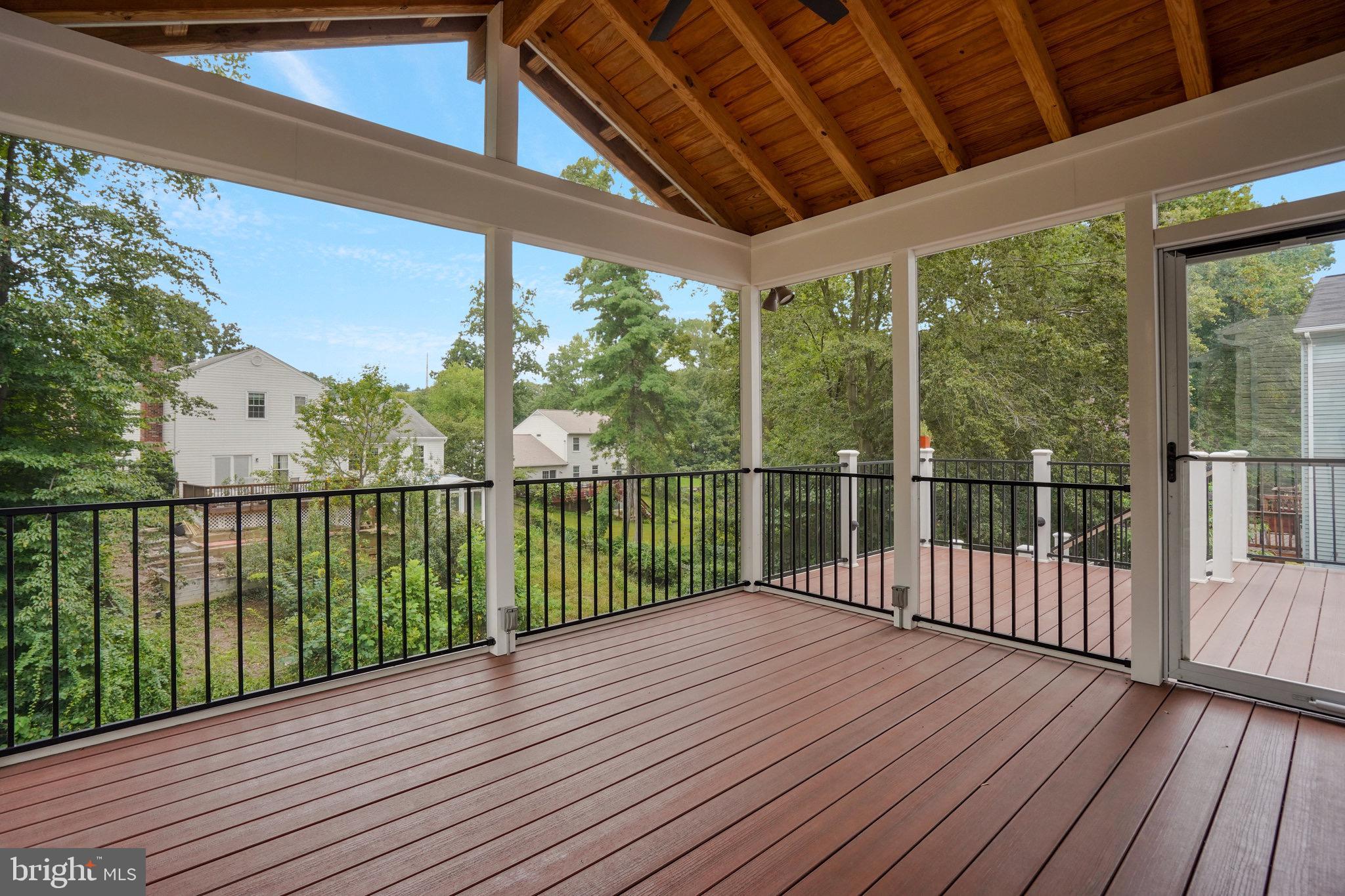 8298 Lindside Way Springfield, VA 22153 - Photo 2 of 38 a view of a balcony with wooden floor