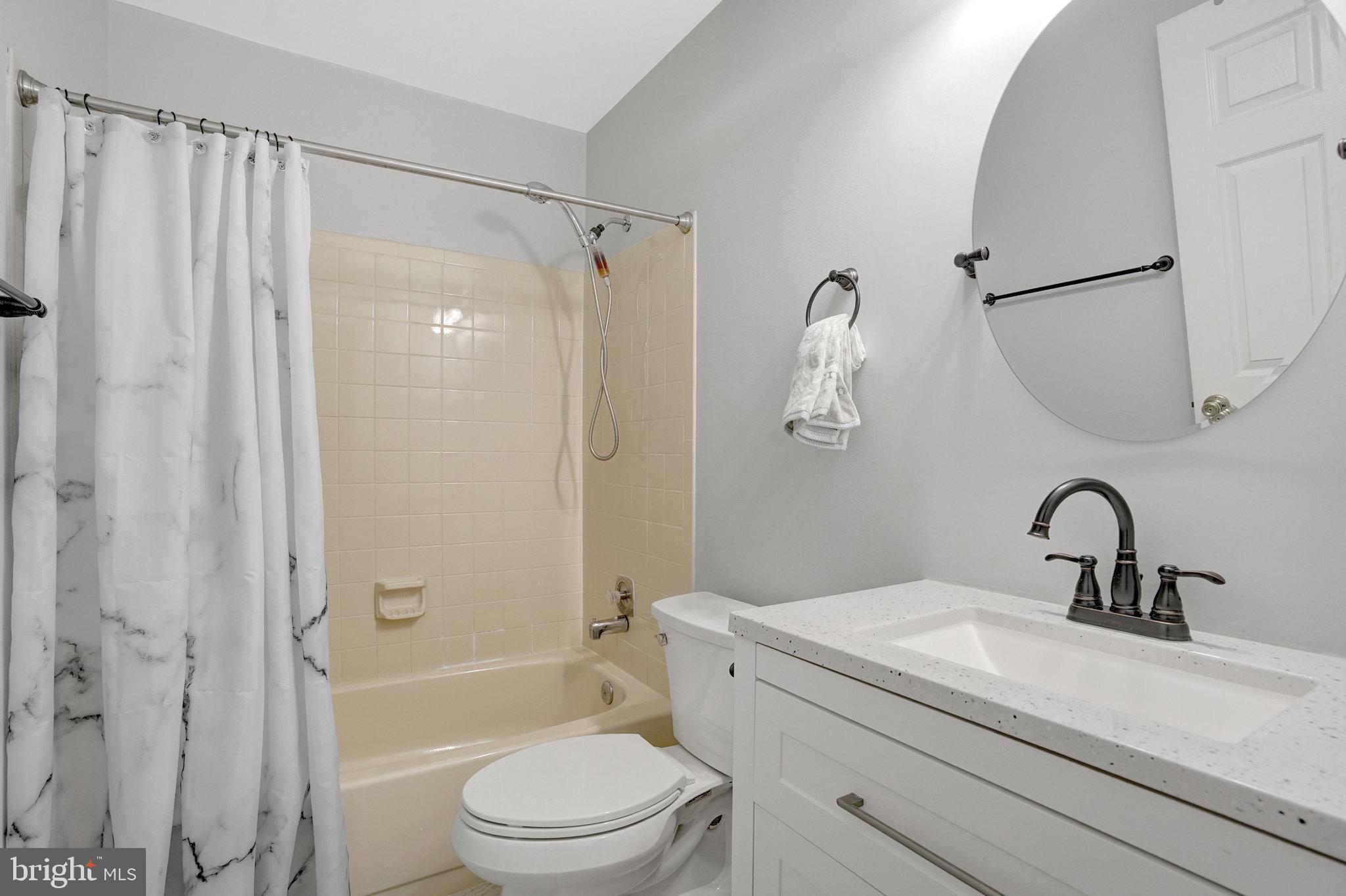 8298 Lindside Way Springfield, VA 22153 - Photo 21 of 38 a bathroom with a sink a toilet and a mirror