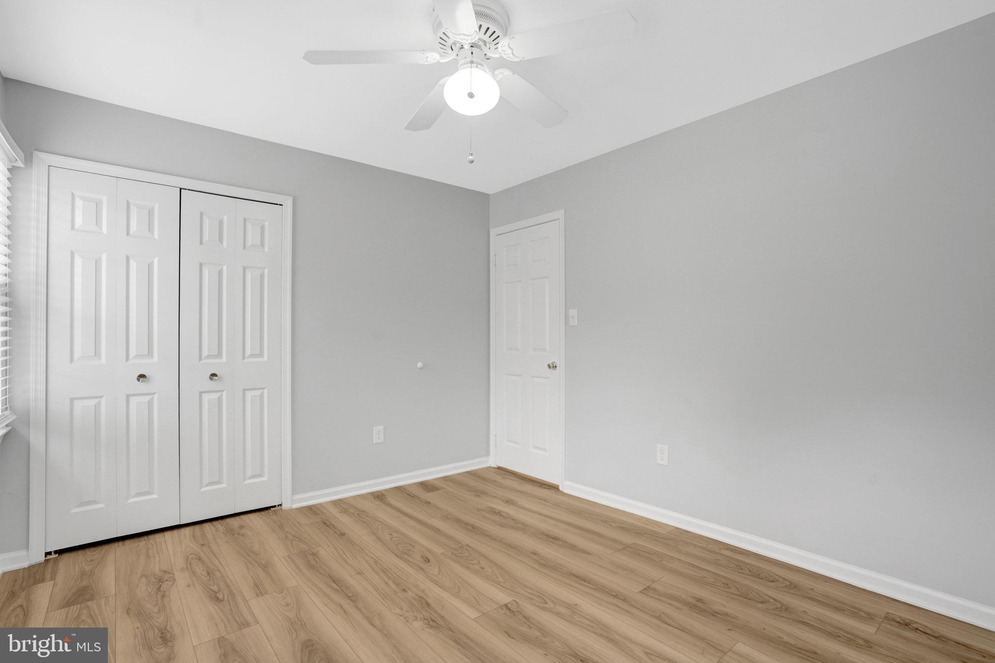 8298 Lindside Way Springfield, VA 22153 - Photo 27 of 38 a view of an empty room with wooden floor