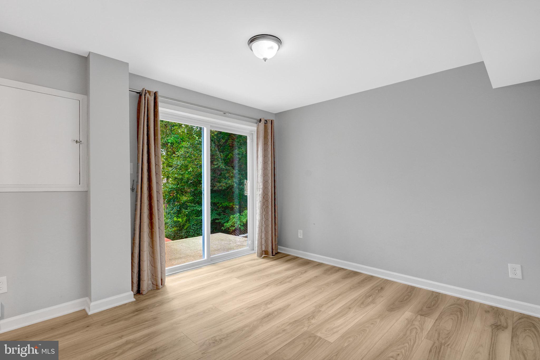 8298 Lindside Way Springfield, VA 22153 - Photo 30 of 38 a view of an empty room with wooden floor and a window