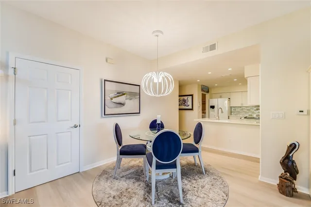 a living room with furniture a rug and a chandelier