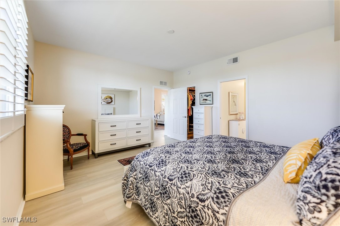4306 Bellasol Circle, Unit 3412 Fort Myers, FL 33916 - Photo 19 of 31 a bedroom with a bed and a refrigerator