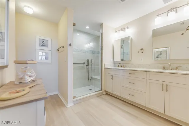a spacious bathroom with a granite countertop sink mirror and shower