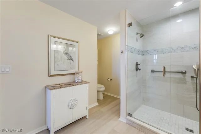 a bathroom with a granite countertop sink mirror and shower