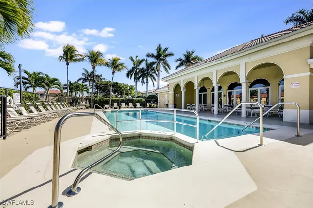 a view of a swimming pool with outdoor seating