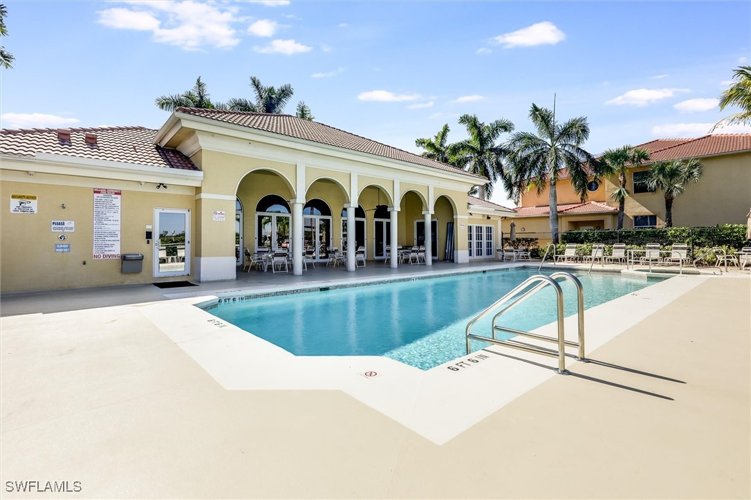 4306 Bellasol Circle, Unit 3412 Fort Myers, FL 33916 - Photo 31 of 31 a view of a swimming pool with outdoor seating