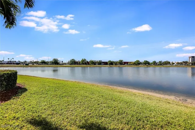a view of a lake with houses in the back