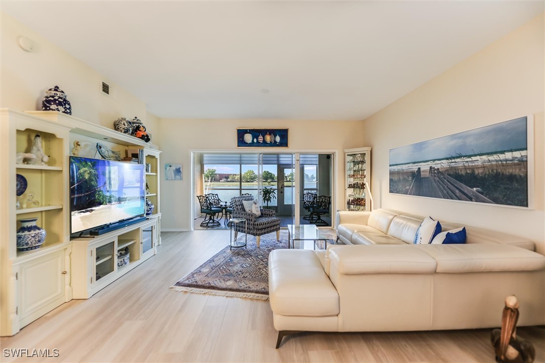 4306 Bellasol Circle, Unit 3412 Fort Myers, FL 33916 - Photo 10 of 31 a living room with furniture and a flat screen tv