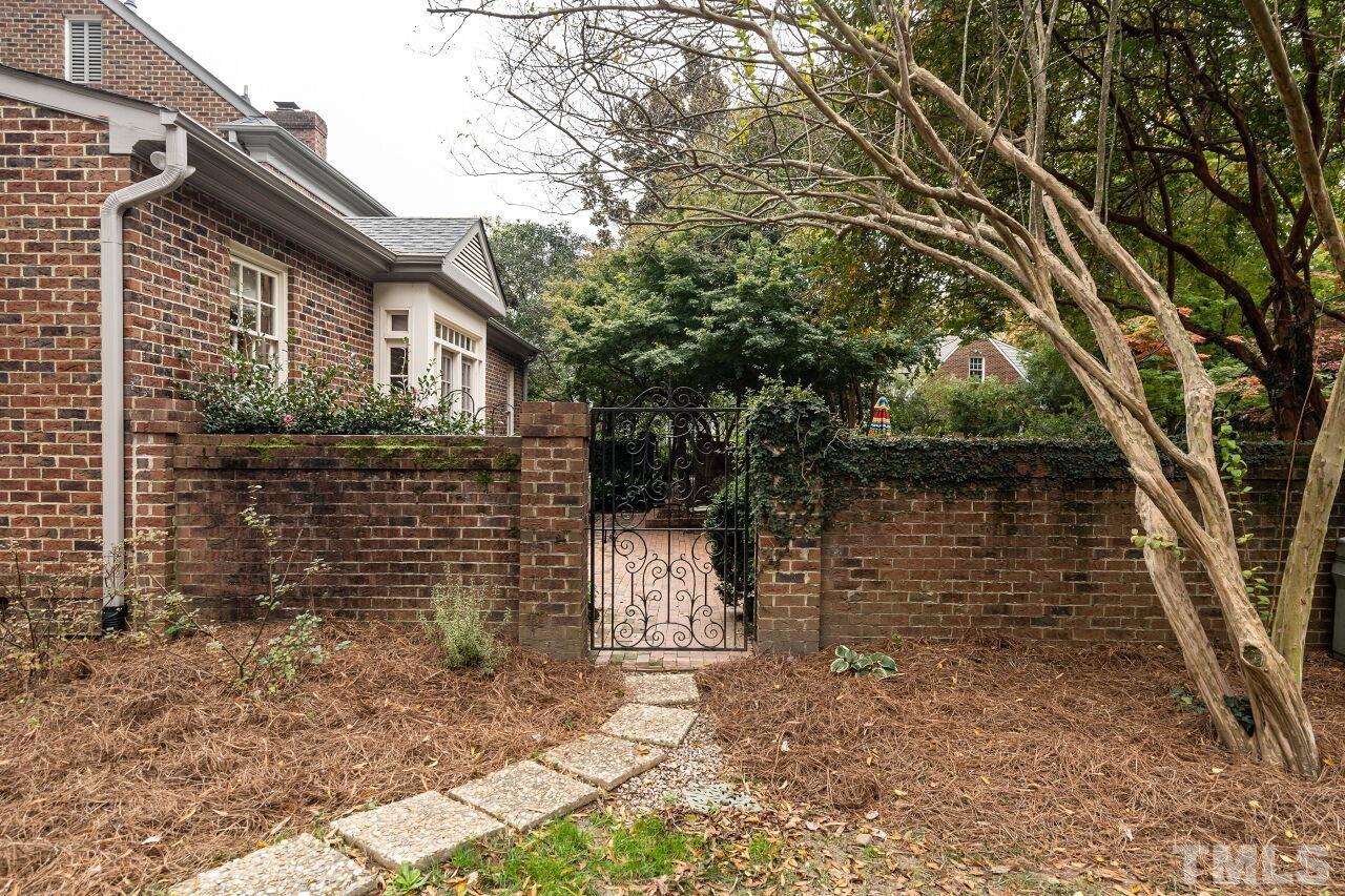 1117 Cowper Drive Raleigh, NC 27608 - Photo 25 of 28 a brick house with tree in front of it