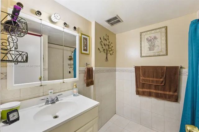 a bathroom with a sink a mirror and a shower