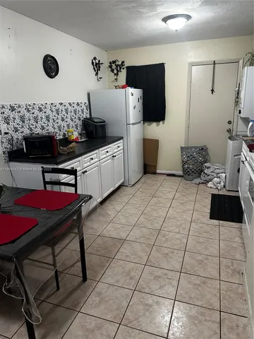 a kitchen with stainless steel appliances a stove a sink and a refrigerator