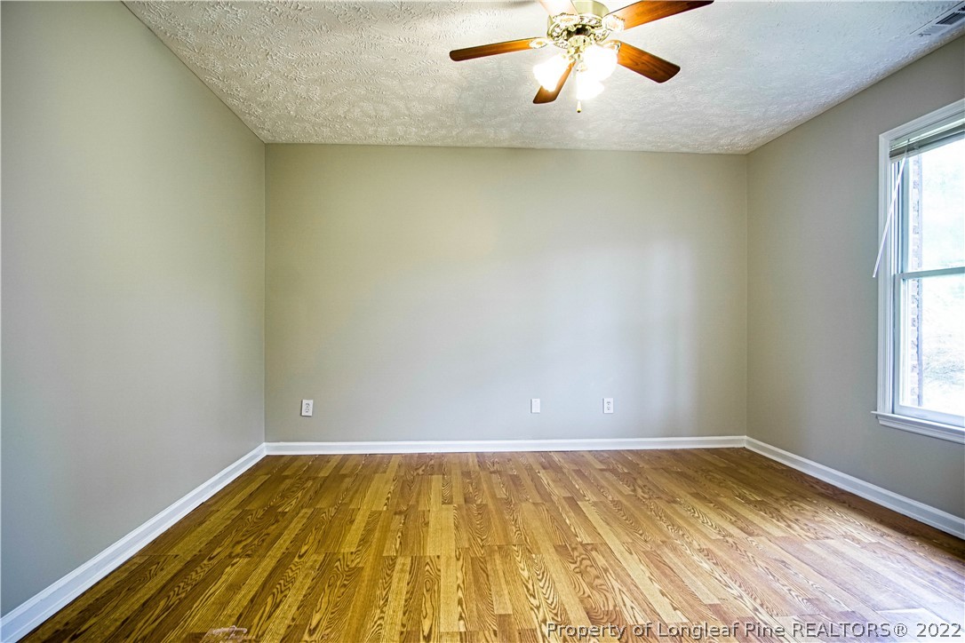 1810 Nuthatch Road Fayetteville, NC 28304 - Photo 13 of 37 wooden floor in an empty room with a window