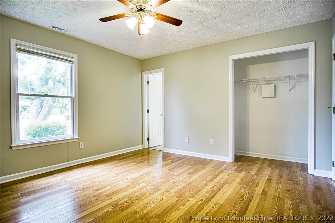 1810 Nuthatch Road Fayetteville, NC 28304 - Photo 14 of 37 a view of an empty room with wooden floor and a window