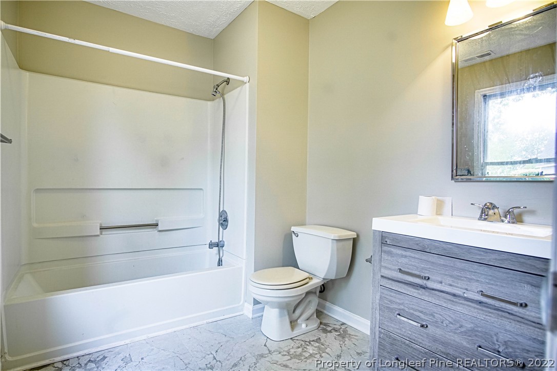 1810 Nuthatch Road Fayetteville, NC 28304 - Photo 16 of 37 a bathroom with a toilet a sink and a bathtub