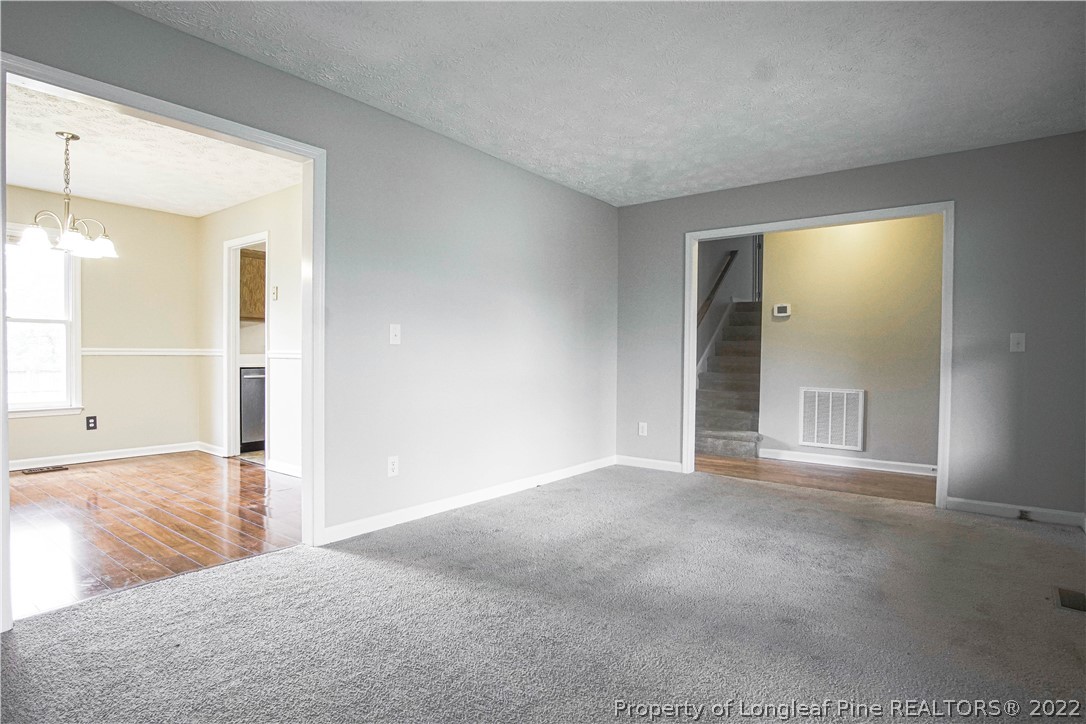 1810 Nuthatch Road Fayetteville, NC 28304 - Photo 18 of 37 a view of an empty room with wooden floor and a window