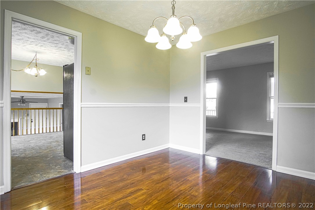 1810 Nuthatch Road Fayetteville, NC 28304 - Photo 19 of 37 wooden floor in an empty room with a window