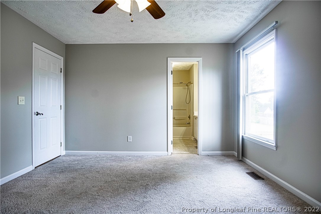 1810 Nuthatch Road Fayetteville, NC 28304 - Photo 23 of 37 an empty room with closet and chandelier fan