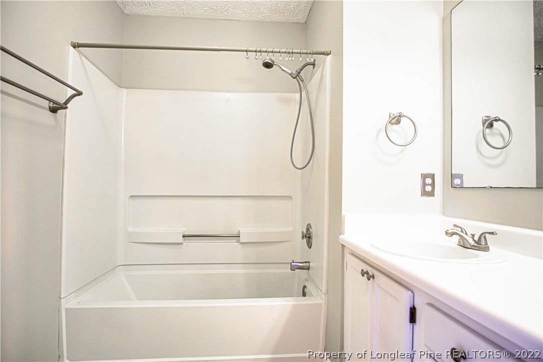 1810 Nuthatch Road Fayetteville, NC 28304 - Photo 25 of 37 a bathroom with a granite countertop sink a mirror and shower