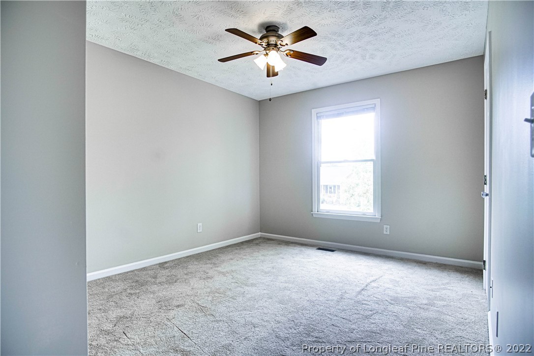 1810 Nuthatch Road Fayetteville, NC 28304 - Photo 26 of 37 an empty room with a window and a ceiling fan