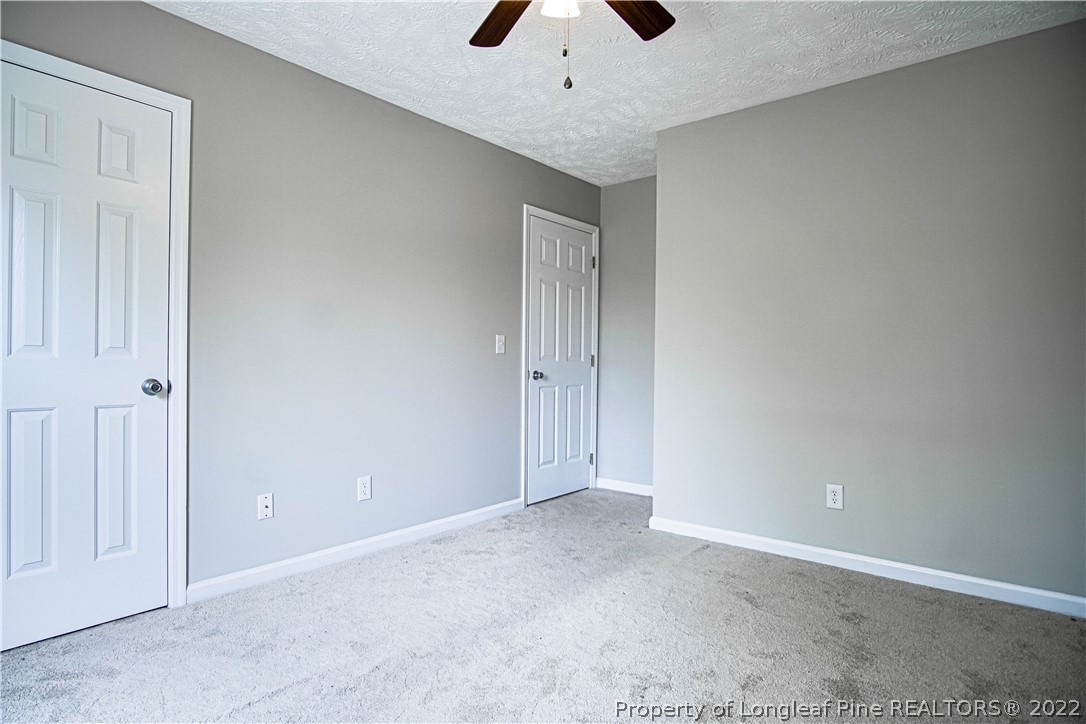 1810 Nuthatch Road Fayetteville, NC 28304 - Photo 27 of 37 an empty room with a ceiling fan and entryway
