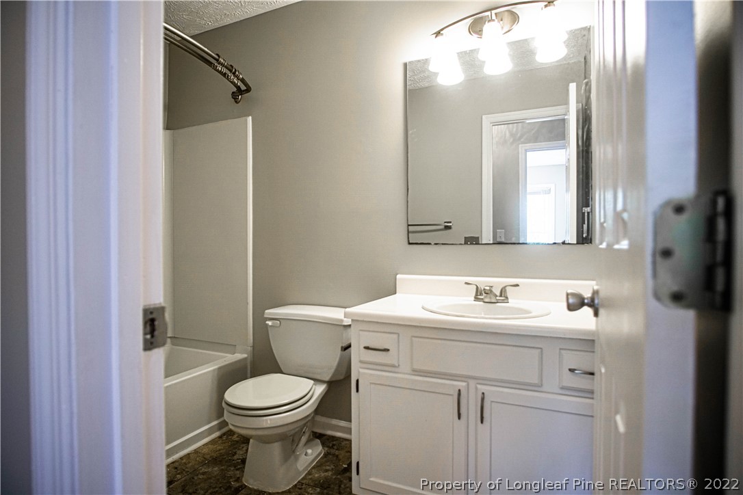 1810 Nuthatch Road Fayetteville, NC 28304 - Photo 28 of 37 a bathroom with a sink toilet and mirror