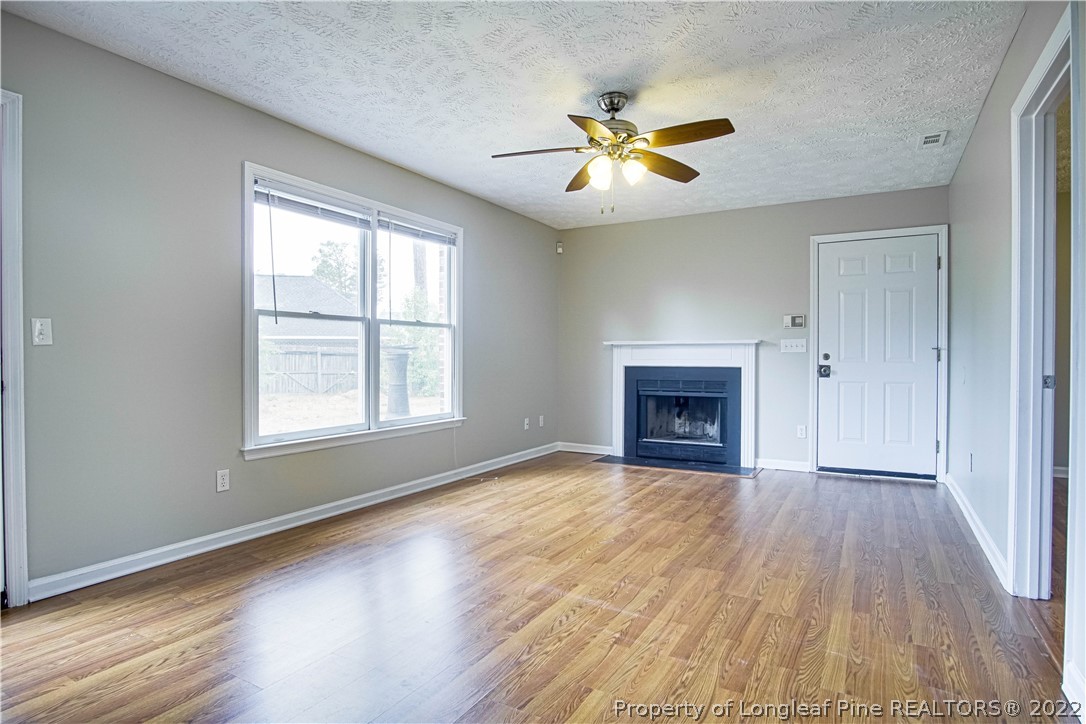 1810 Nuthatch Road Fayetteville, NC 28304 - Photo 7 of 37 a view of an empty room with a window and fireplace