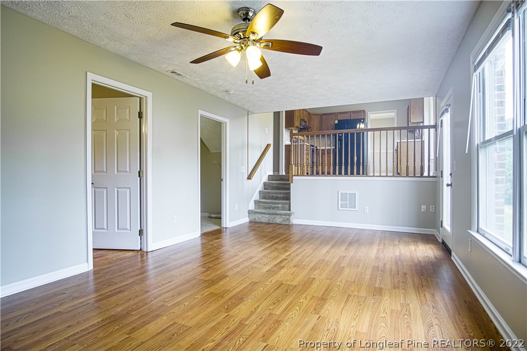 1810 Nuthatch Road Fayetteville, NC 28304 - Photo 9 of 37 an empty room with wooden floor and windows