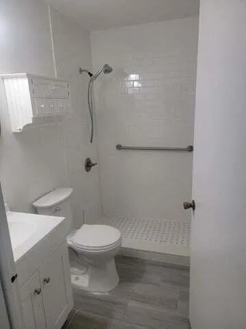 a bathroom with a toilet and a shower