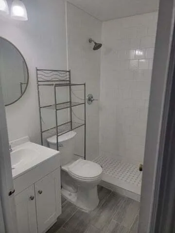 a bathroom with a toilet a sink and shower