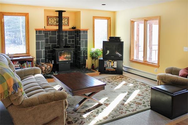 93 Lower Pomeroy Road Montgomery, MA 01085 - Photo 12 of 20 a living room with furniture and a fireplace