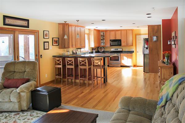 93 Lower Pomeroy Road Montgomery, MA 01085 - Photo 13 of 20 a living room with stainless steel appliances furniture wooden floor and a kitchen view