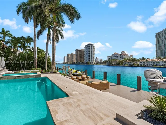 a living room with furniture and floor to ceiling windows