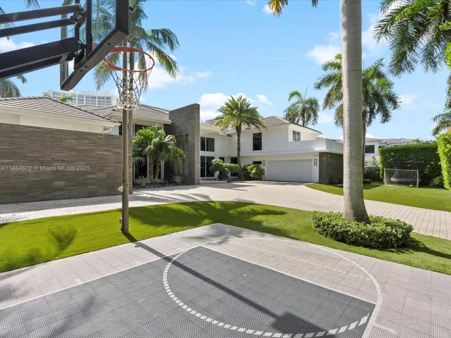 a living room with patio furniture and a floor to ceiling window