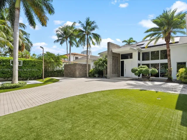 a patio with a table and chairs and potted plants