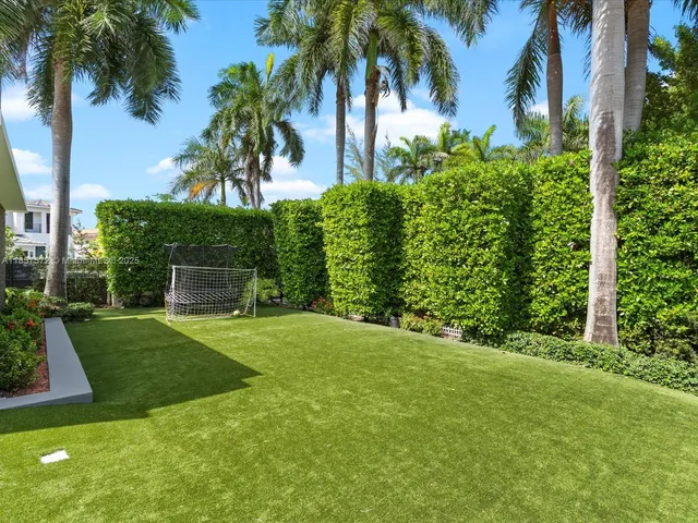 a aerial view of a house with a garden and lake view