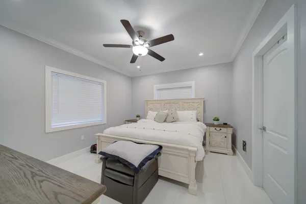 a bedroom with a bed and a ceiling fan