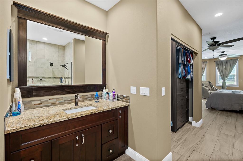 4895 State Rte 100 Bunnell, FL 32110 - Photo 20 of 45 a en suite bathroom with a double vanity sink and a mirror