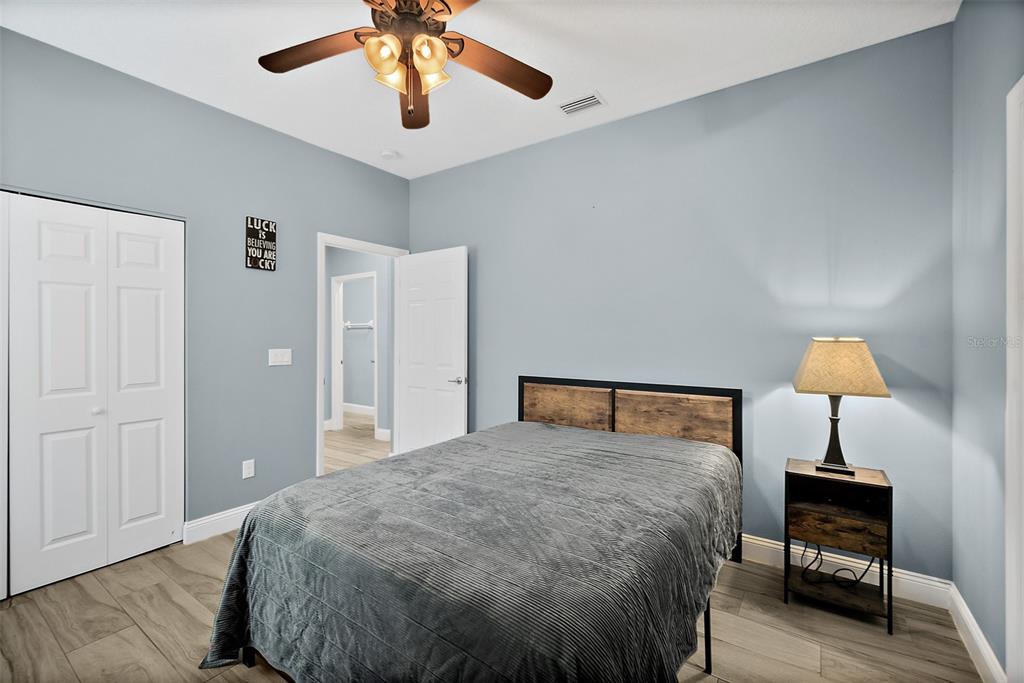 4895 State Rte 100 Bunnell, FL 32110 - Photo 22 of 45 a bedroom with a bed and a lamp